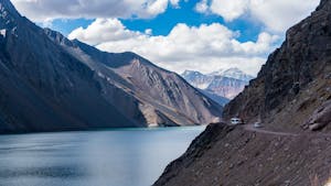 Breathtaking view of the Andes mountains and serene lake in Santiago Metropolitan Region, Chile.